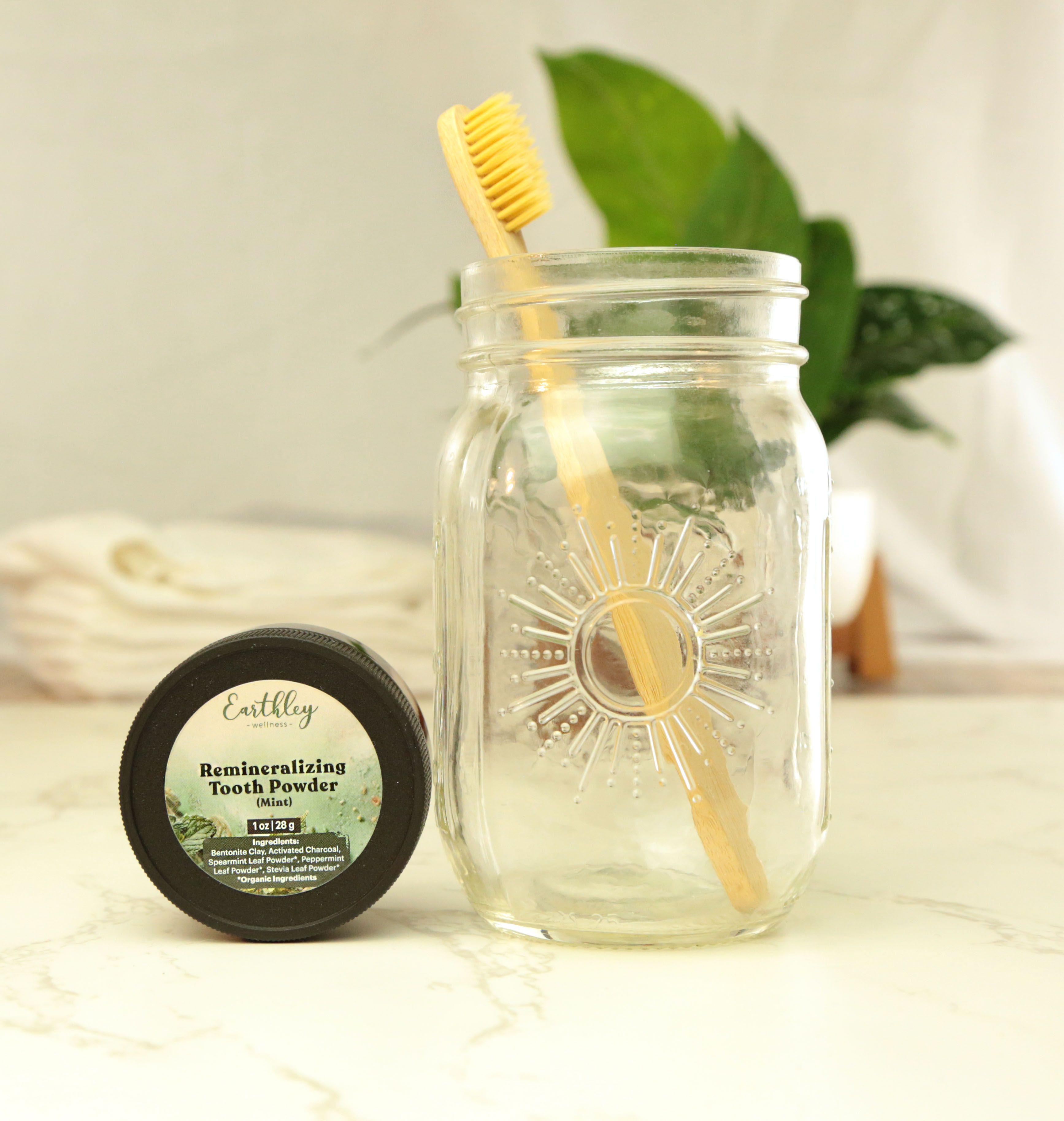 Earthley product lifestyle photo on rustic wood surface with potted herbs in background