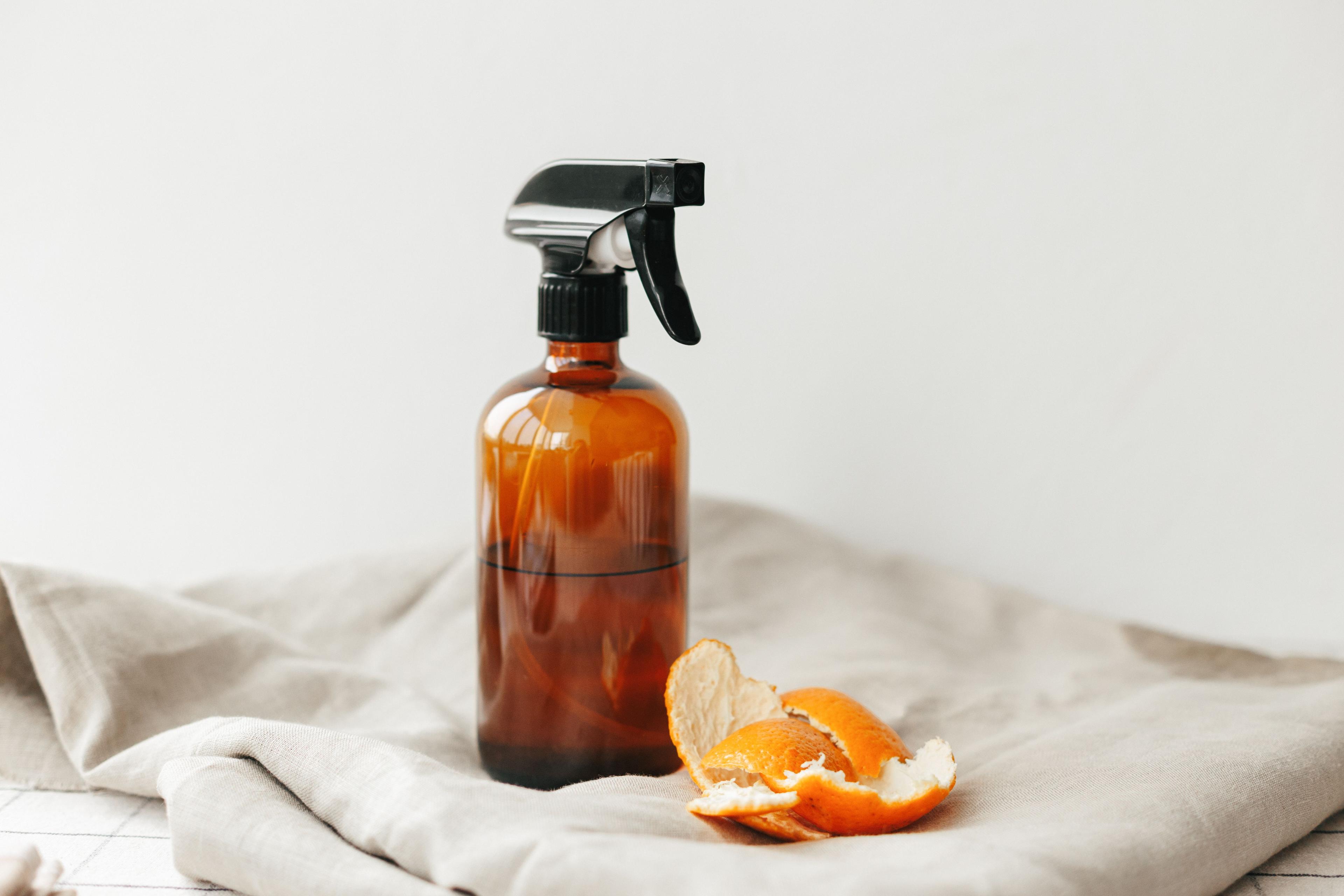 Fresh orange turmeric root pieces with bright orange interior on rustic brown wooden surface