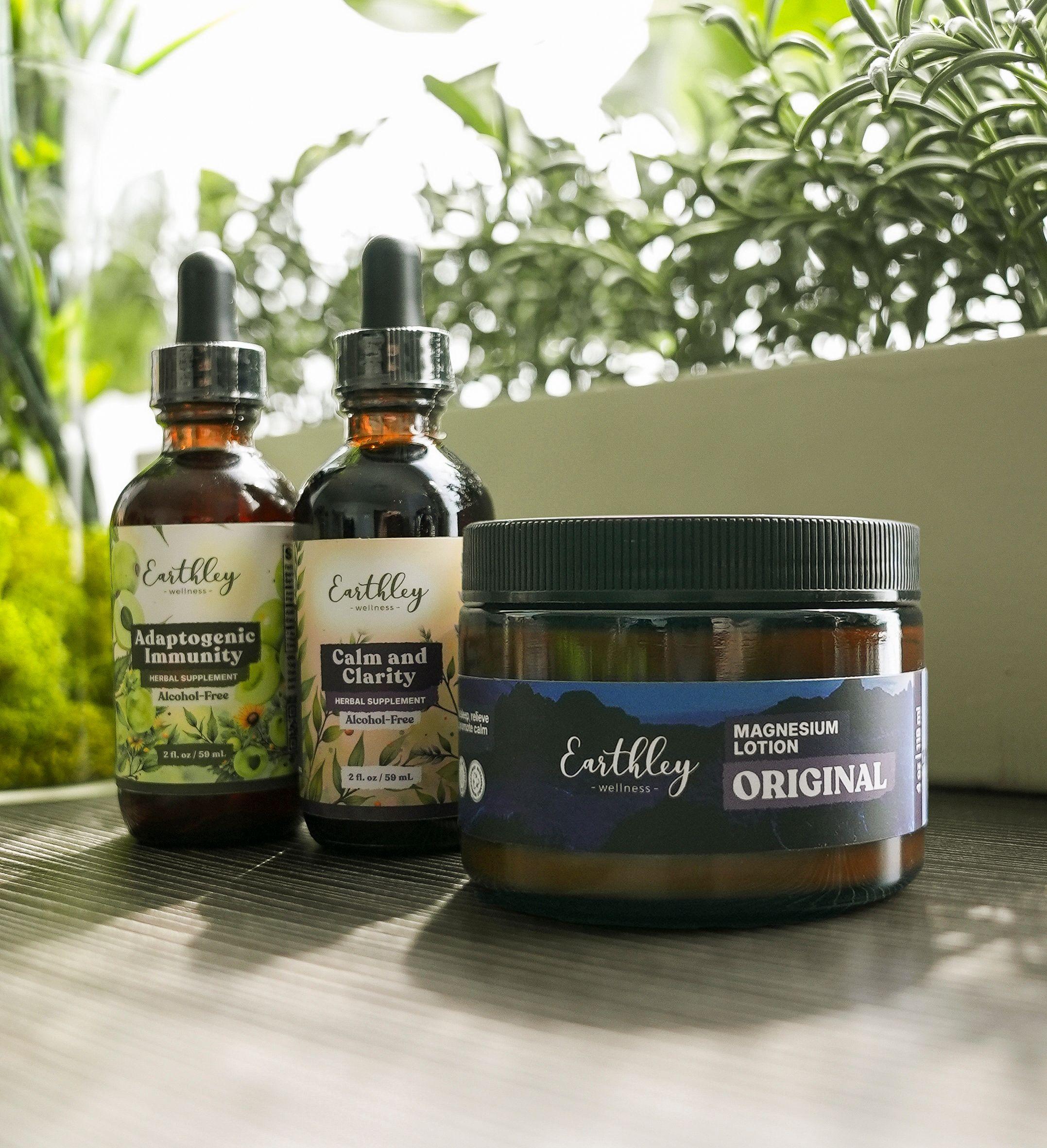 Three Earthley Wellness products: Adaptogenic Immunity, Calm and Clarity tinctures, and Original Magnesium Lotion jar.