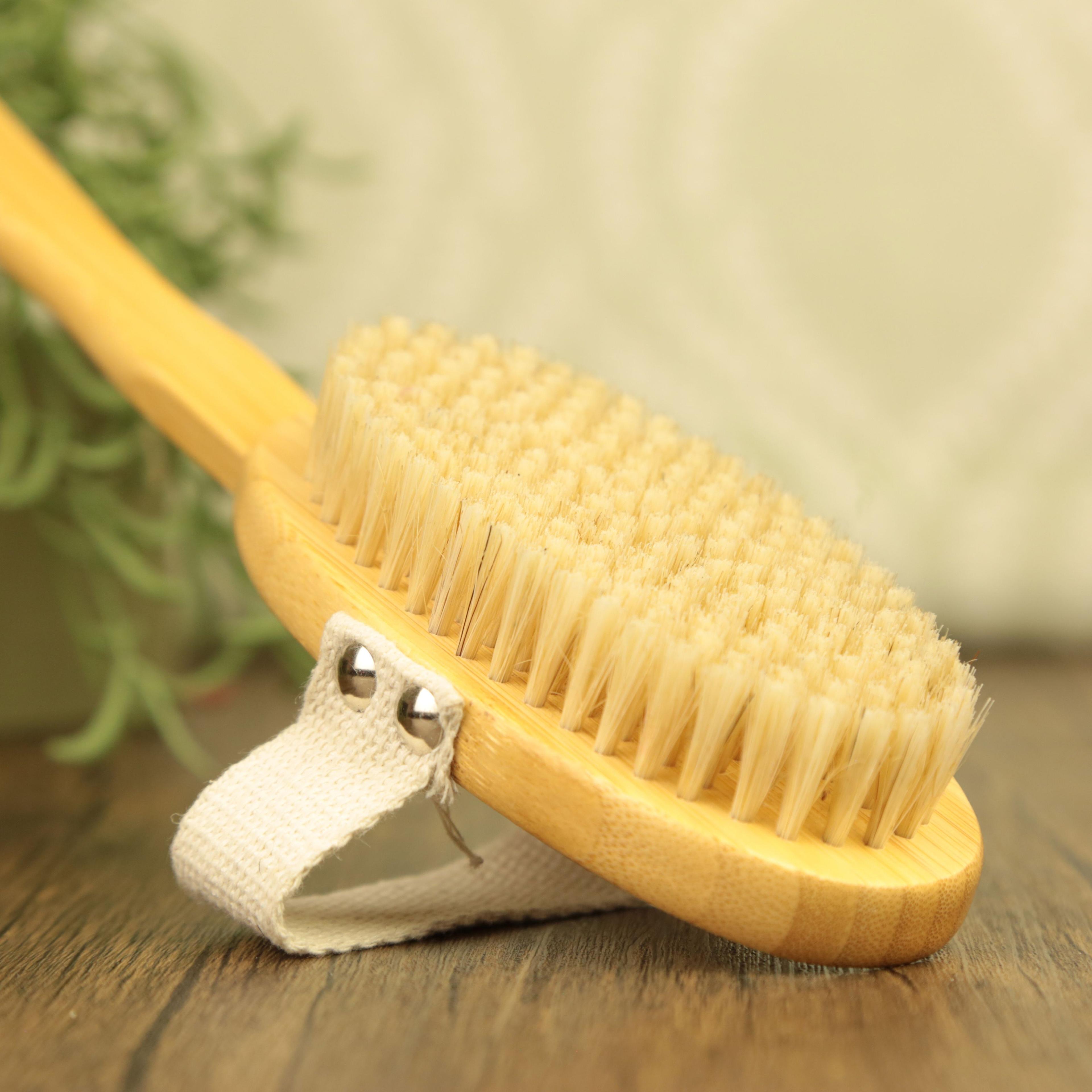 Natural bamboo dry brush with long handle and cotton strap for body exfoliation and wellness