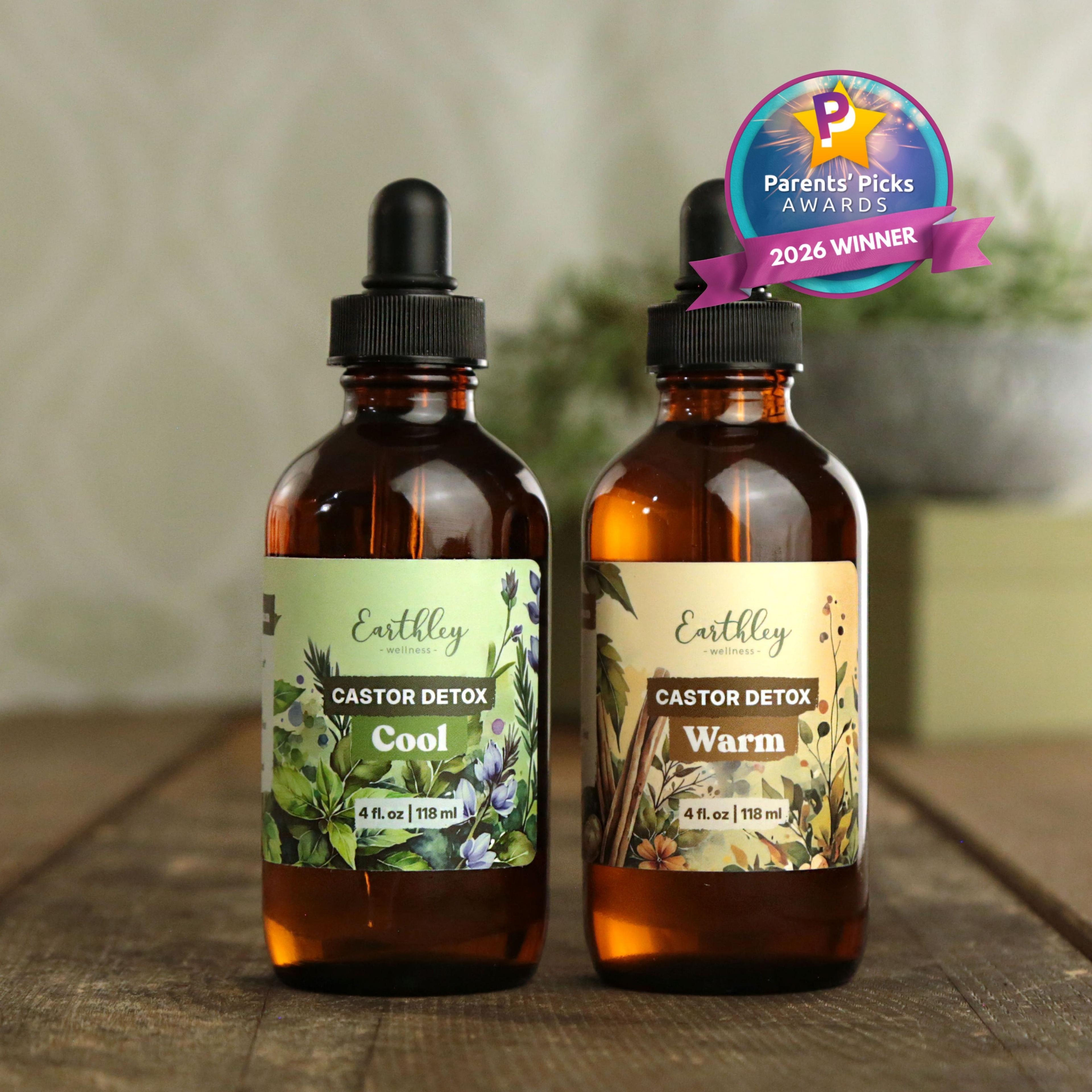Two amber glass dropper bottles of Earthley Castor Detox tinctures - Cool and Warm varieties with Parents' Picks 2026 Winner badge