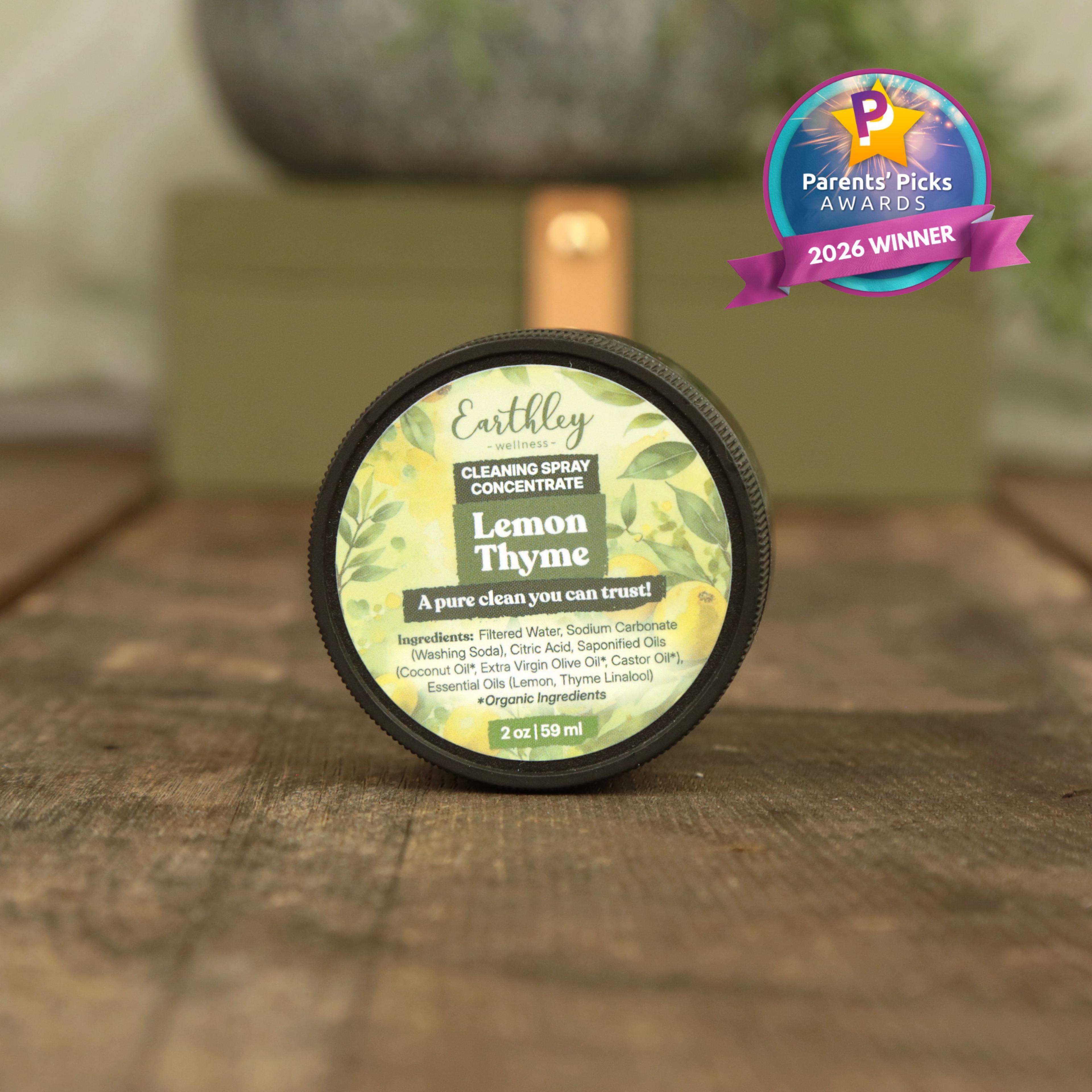 Earthley Lemon Thyme cleaning spray concentrate jar with Parents' Picks Awards 2026 Winner badge on wooden surface