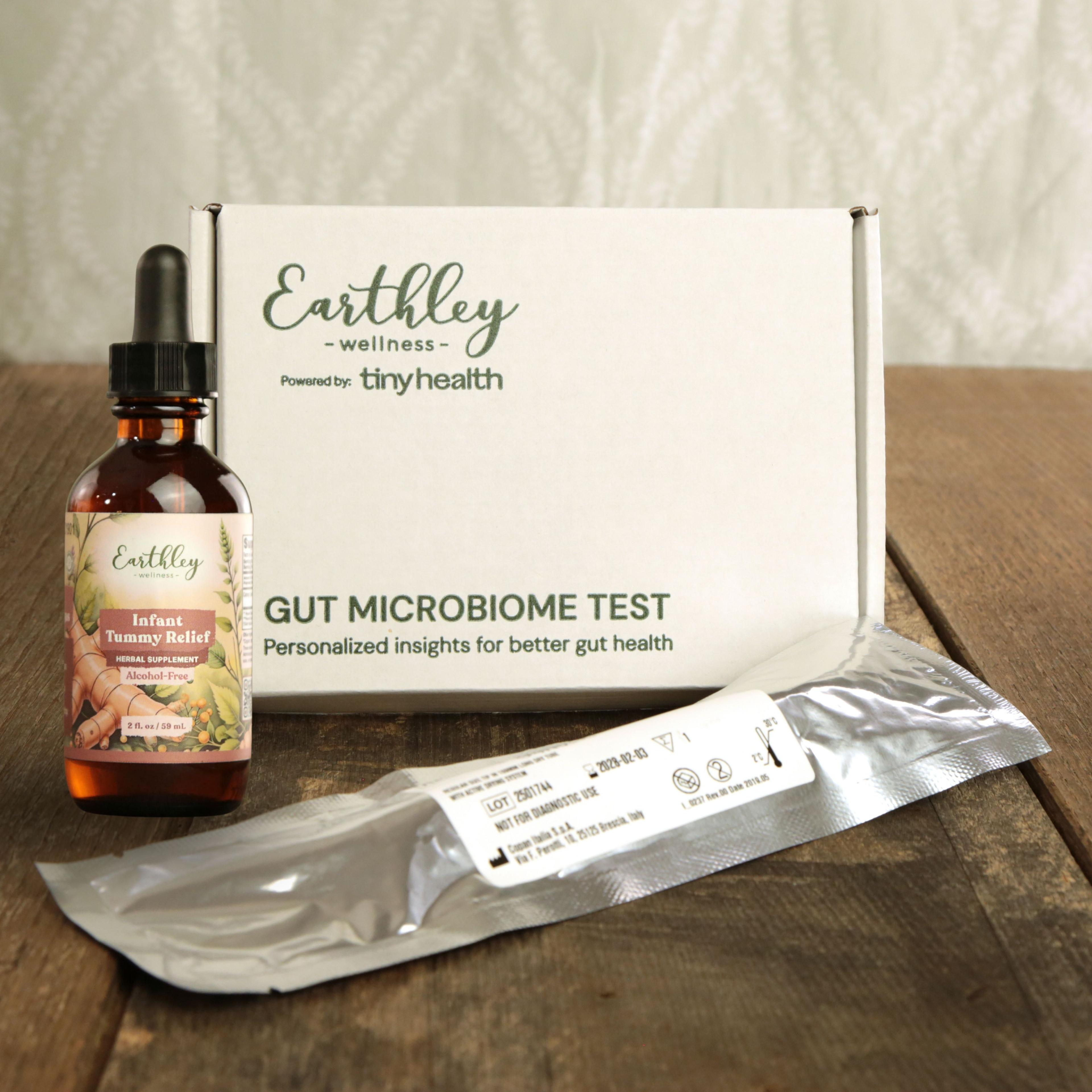Earthley Gut Microbiome Test kit with Instant Tummy Relief tincture bottle and test collection materials on wooden surface