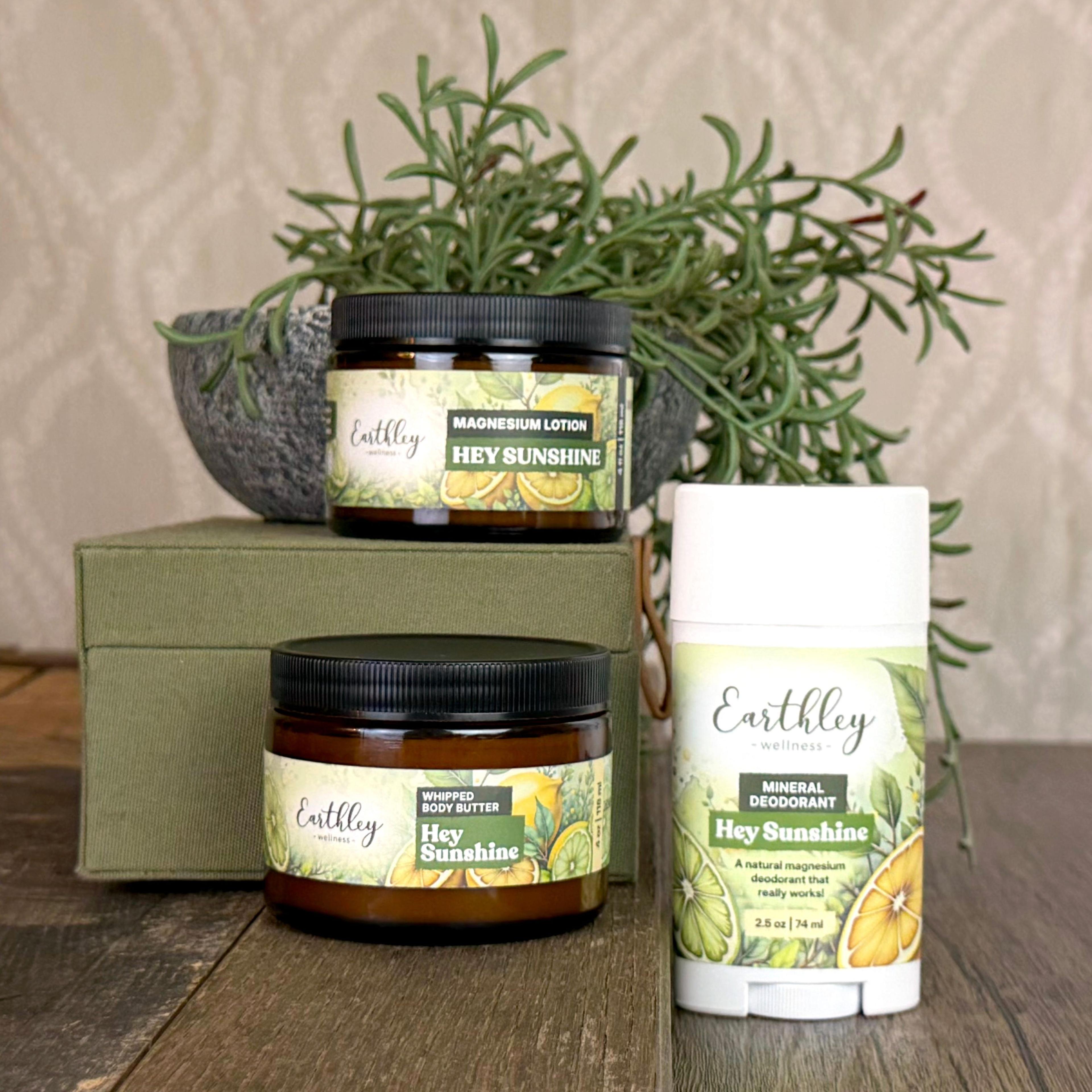 Earthley Hey Sunshine product collection featuring magnesium lotion, whipped body butter, and mineral deodorant with citrus botanical labels
