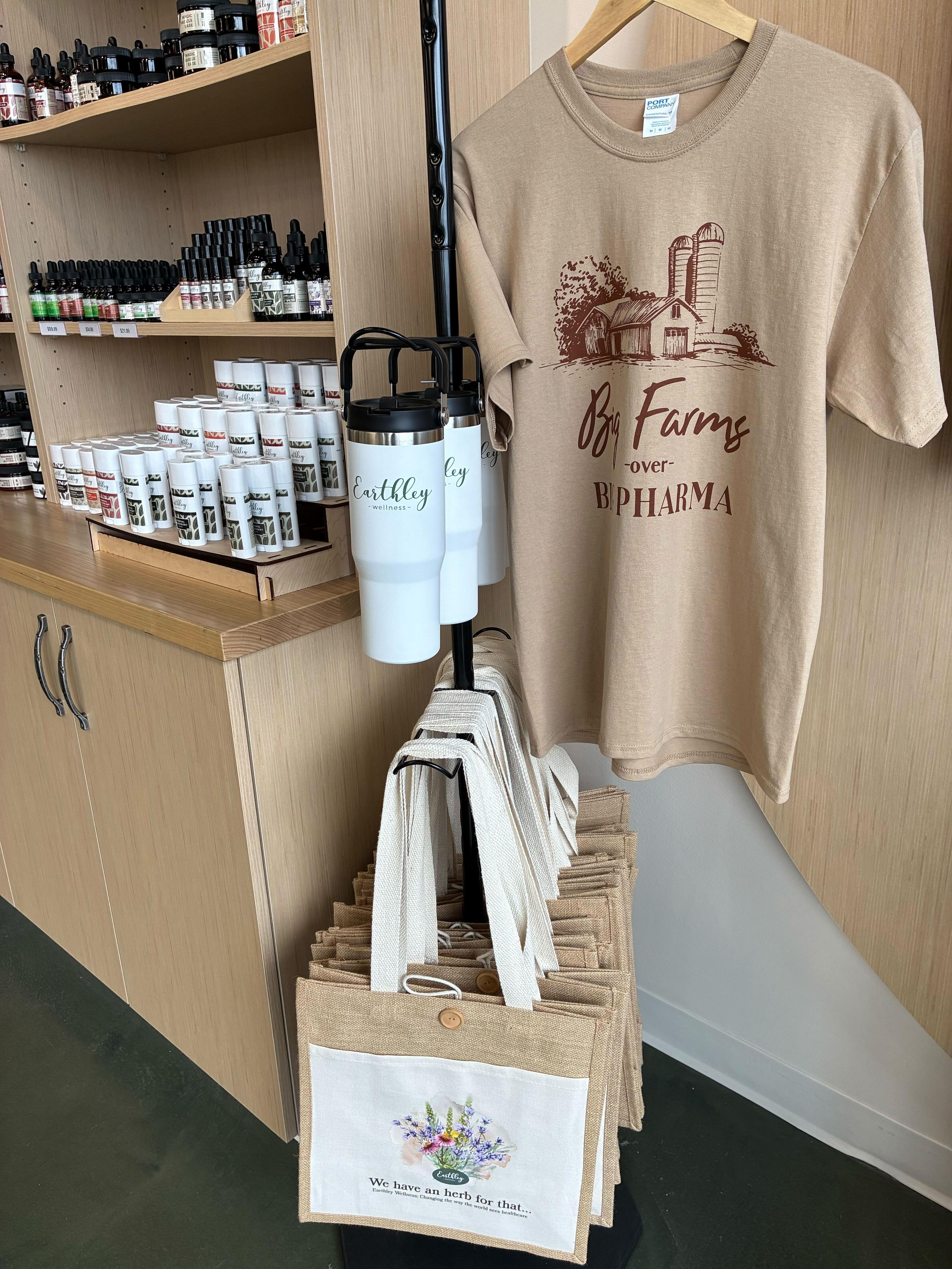 Earthley product lifestyle photo showing tincture bottles on rustic wood with dried herbs and botanical elements