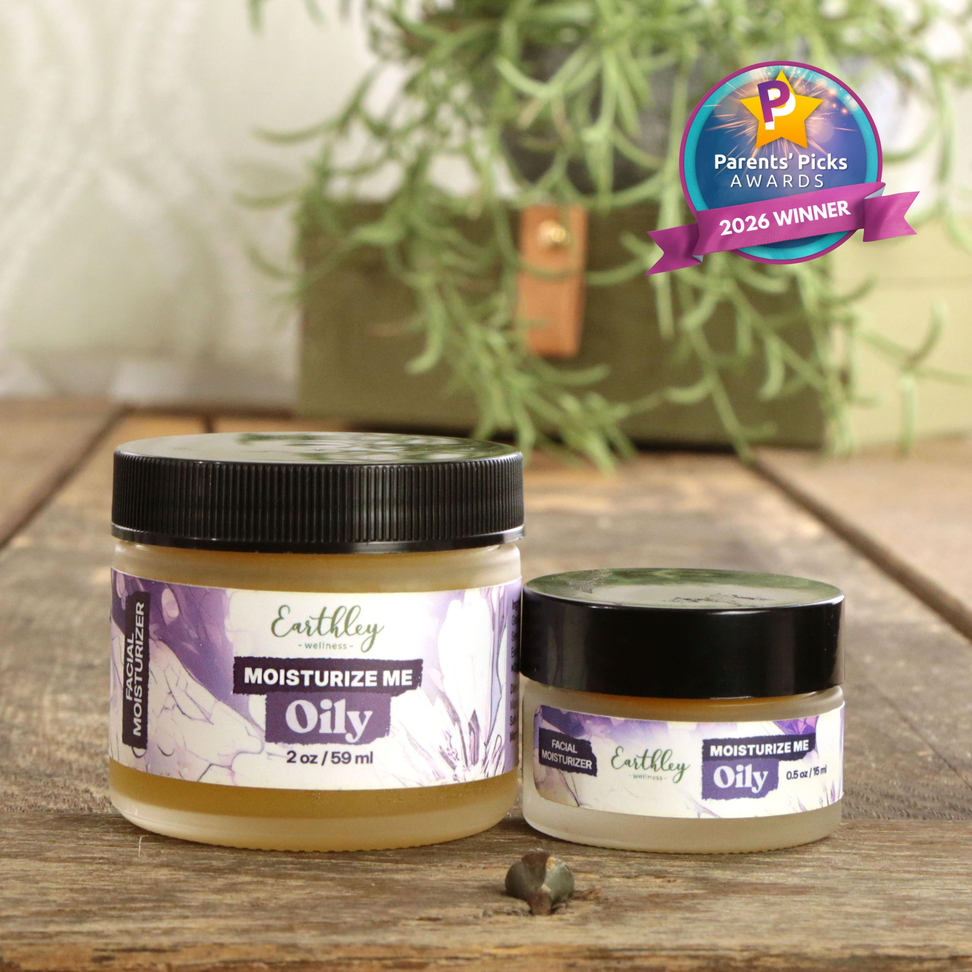 Two jars of Earthley Moisturize Me Oily facial moisturizer with purple labels, featuring Parents' Picks Awards 2026 Winner badge