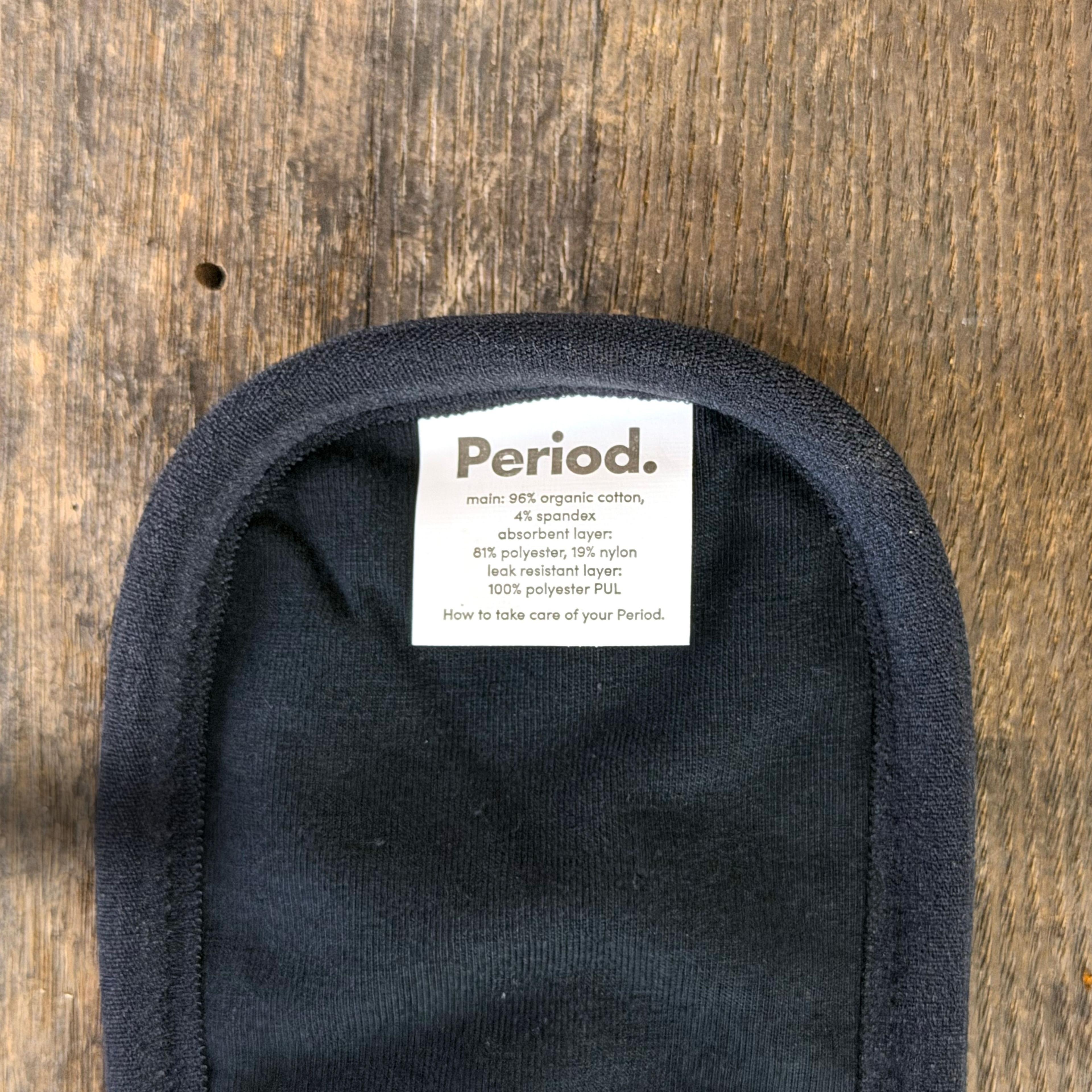 Black period underwear interior label showing organic cotton and leak-resistant layers
