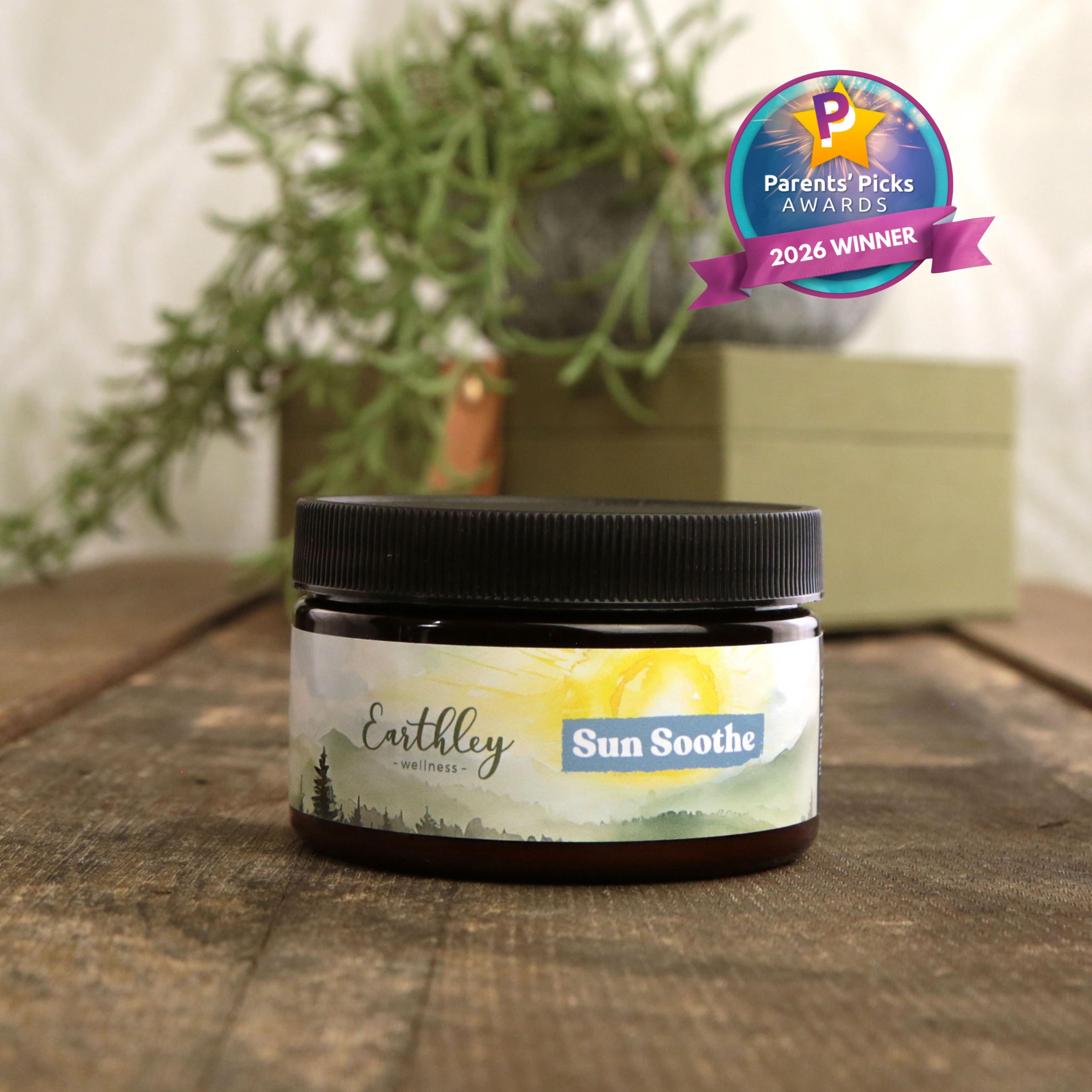 Earthley Sun Soothe salve jar with black lid on wooden surface, featuring Parents' Picks Awards 2026 Winner badge