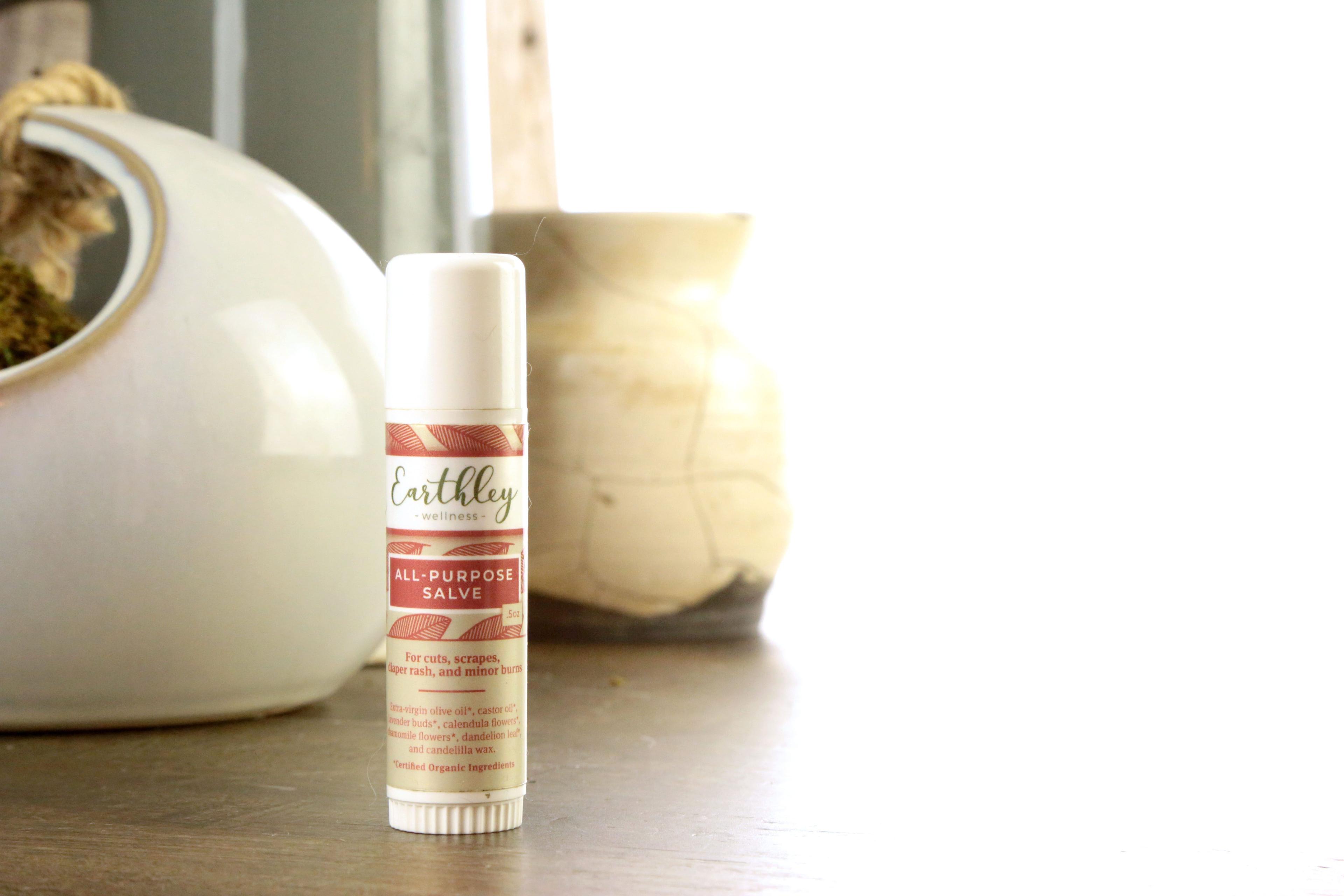 Earthley All-Purpose Salve Stick 0.5oz twist-up tube with pink botanical leaf pattern label for on-the-go skin healing and first aid