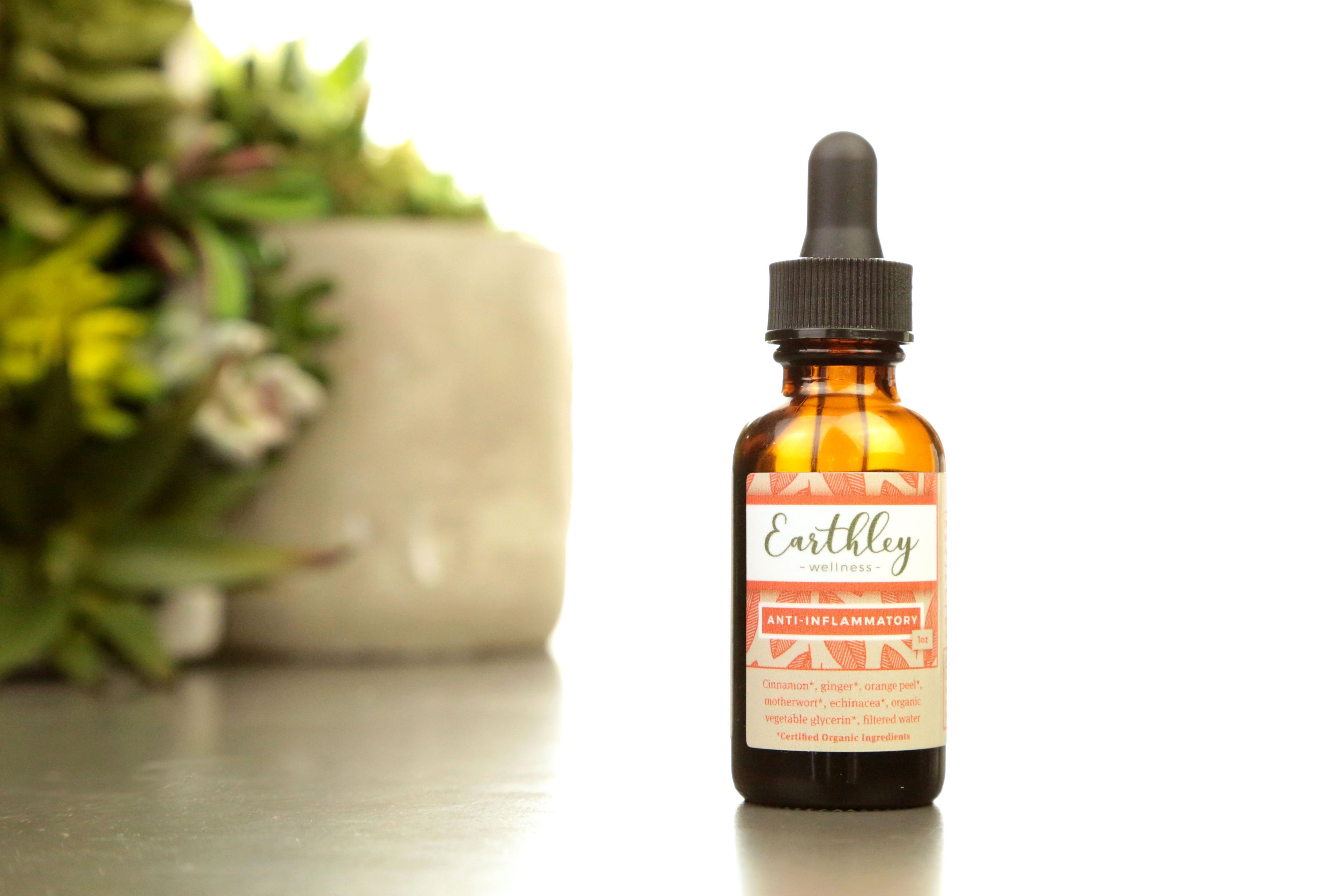 Earthley Anti-Inflammatory tincture bottle with orange geometric pattern label listing ingredients cinnamon ginger orange peel motherwort echinacea