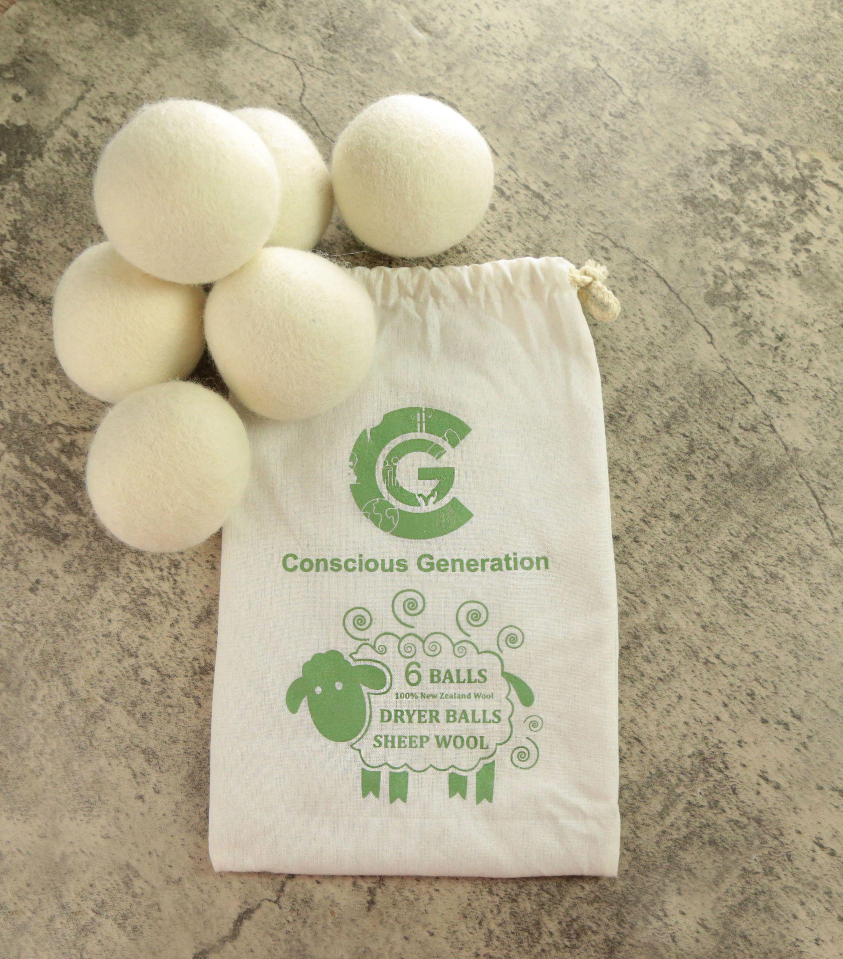 Earthley Wool Dryer Balls set arranged in triangle formation showing natural cream colored felted wool on marble surface