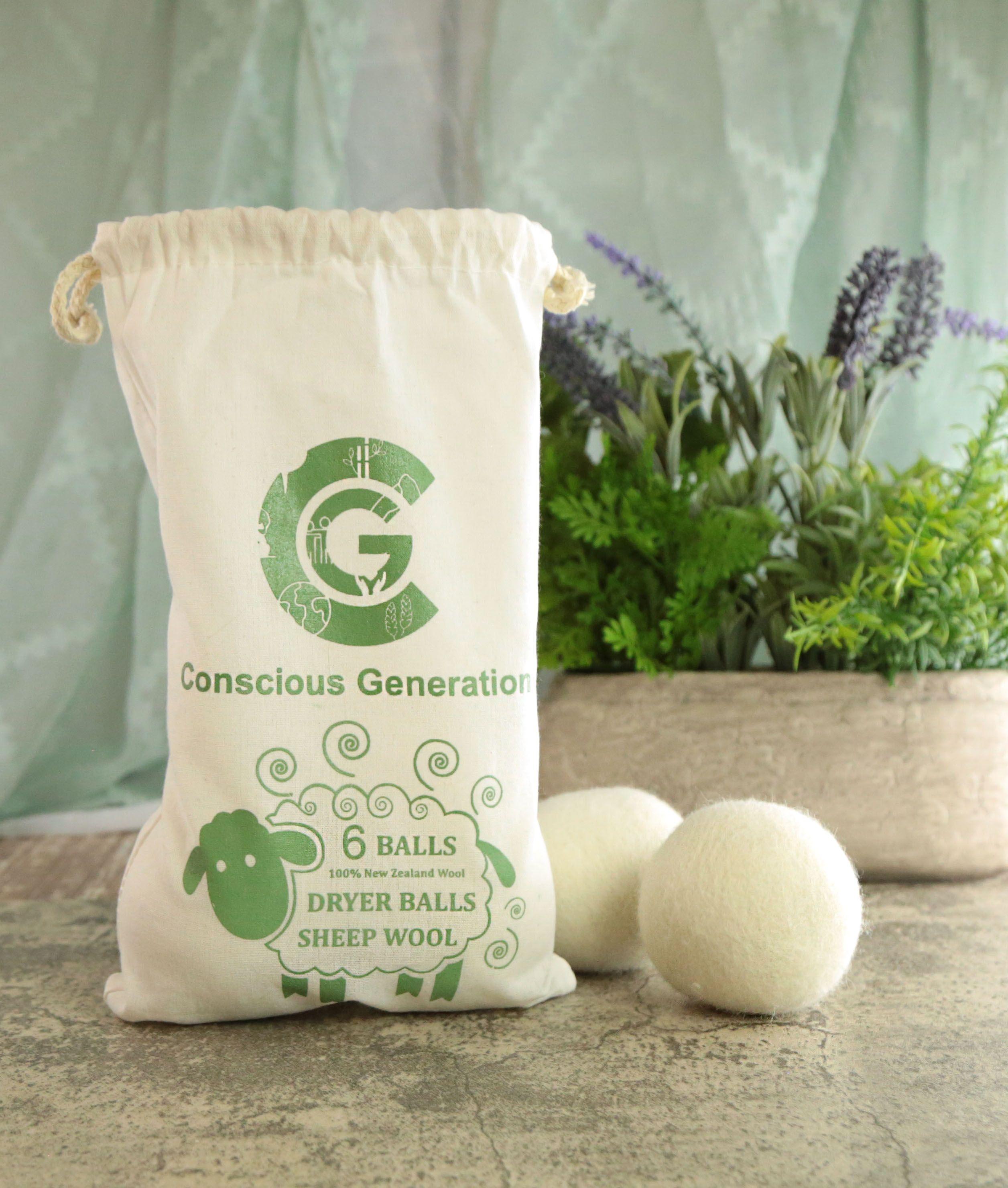 Earthley Wool Dryer Balls set of three natural white felted wool balls on marble surface with eucalyptus sprigs