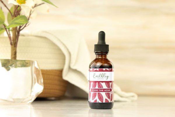 Ease the Ache herbal extract in amber dropper bottle with burgundy leaf label