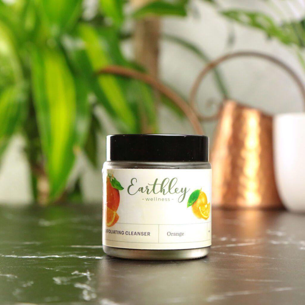Exfoliating Cleanser Orange scent in jar with citrus fruit illustrations on label