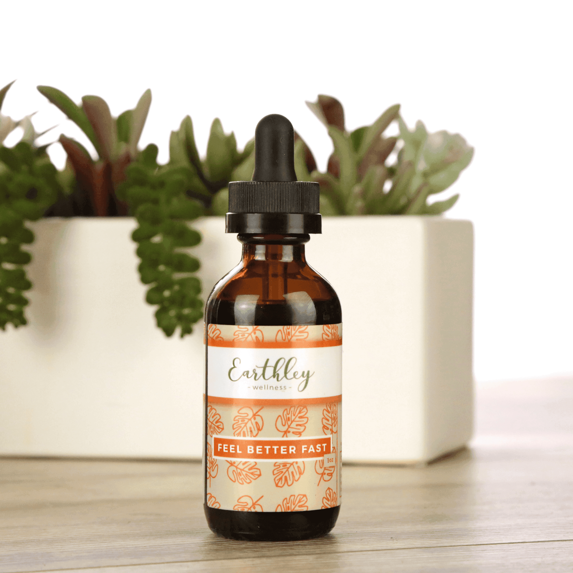 Earthley Feel Better Fast tincture bottle with orange floral pattern label and succulent plants