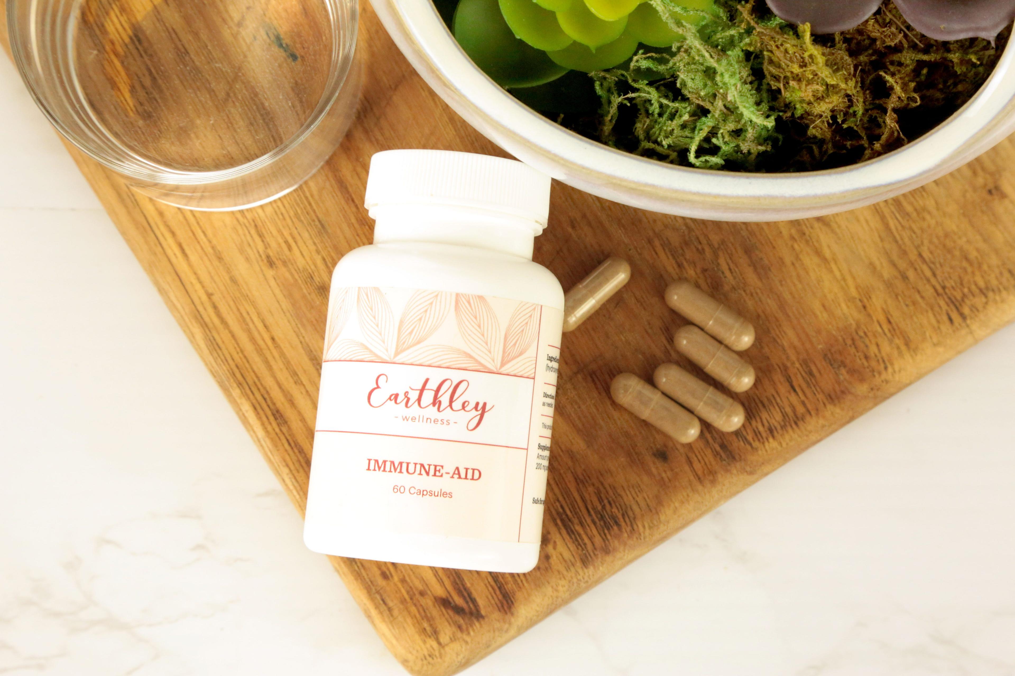 Earthley Immune Aid vitamin C powder amber jar with bright orange label for immune system support
