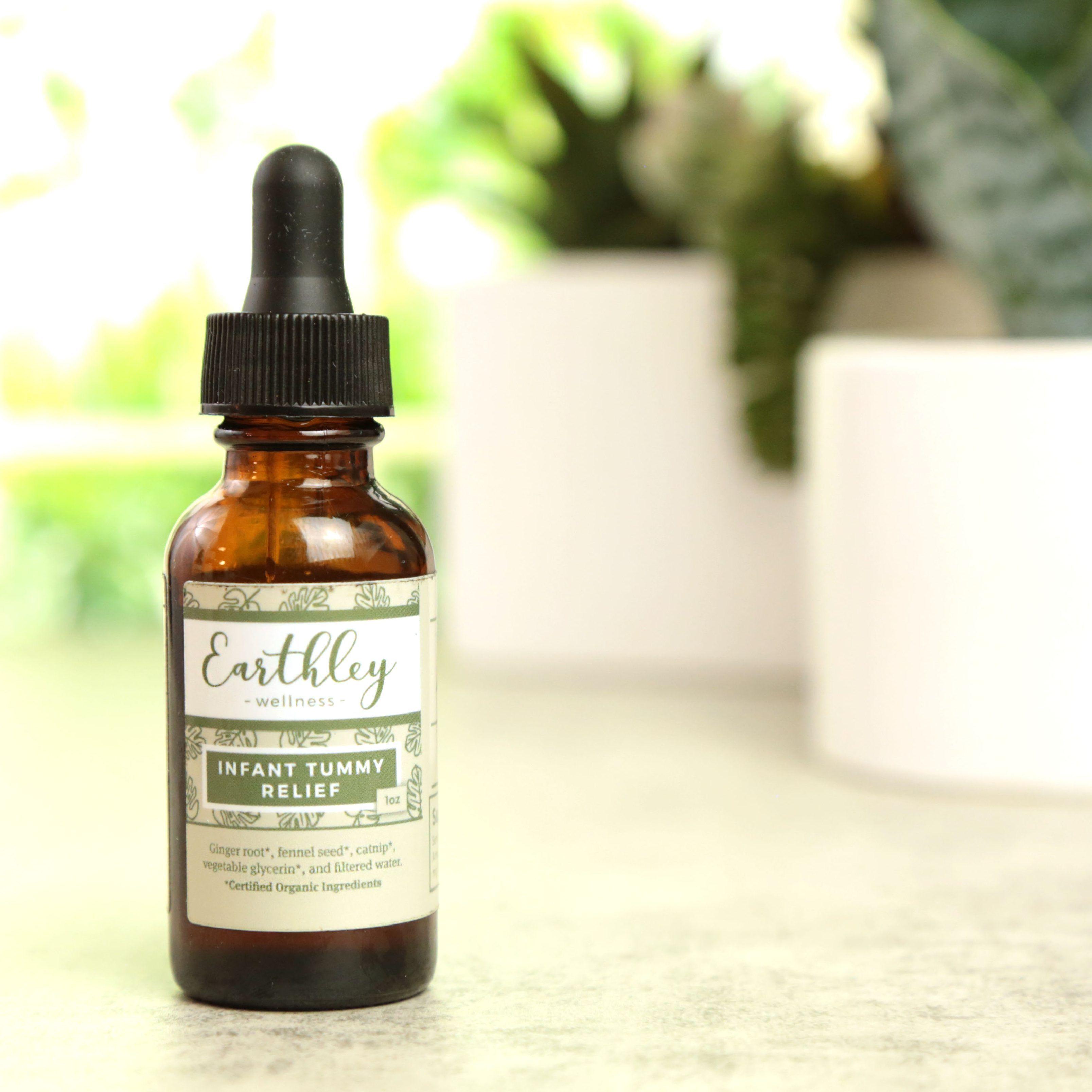 Earthley Infant Tummy Relief herbal extract amber dropper bottle with pink floral label for baby digestive comfort
