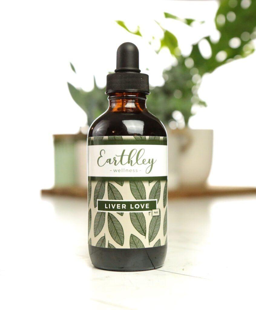 Liver Love herbal extract in amber dropper bottle with green label surrounded by succulents