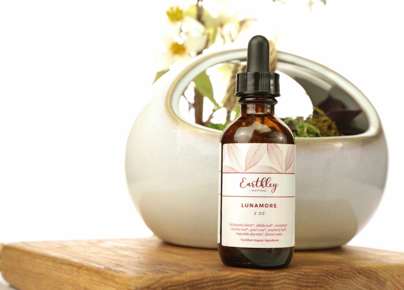 Earthley Lunamore menstrual support amber dropper bottle with purple moon phase label
