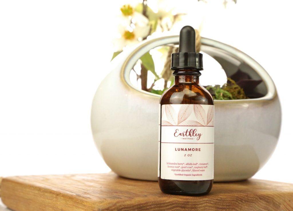 Lunamore 2oz herbal extract in amber dropper bottle with pink leaf label and orchid