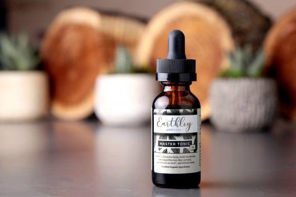 Master Tonic herbal extract in amber dropper bottle with black and white geometric label