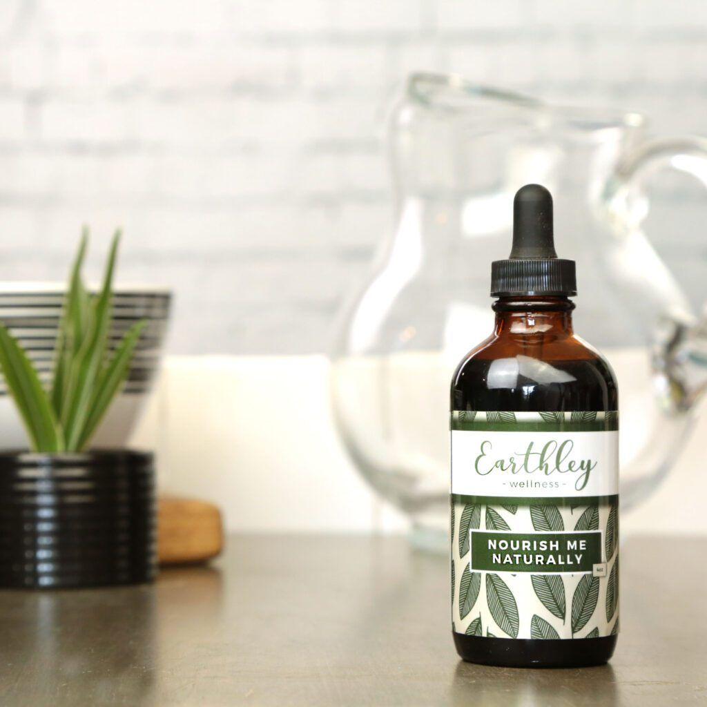 Nourish Me Naturally herbal extract in amber dropper bottle with green leaf label