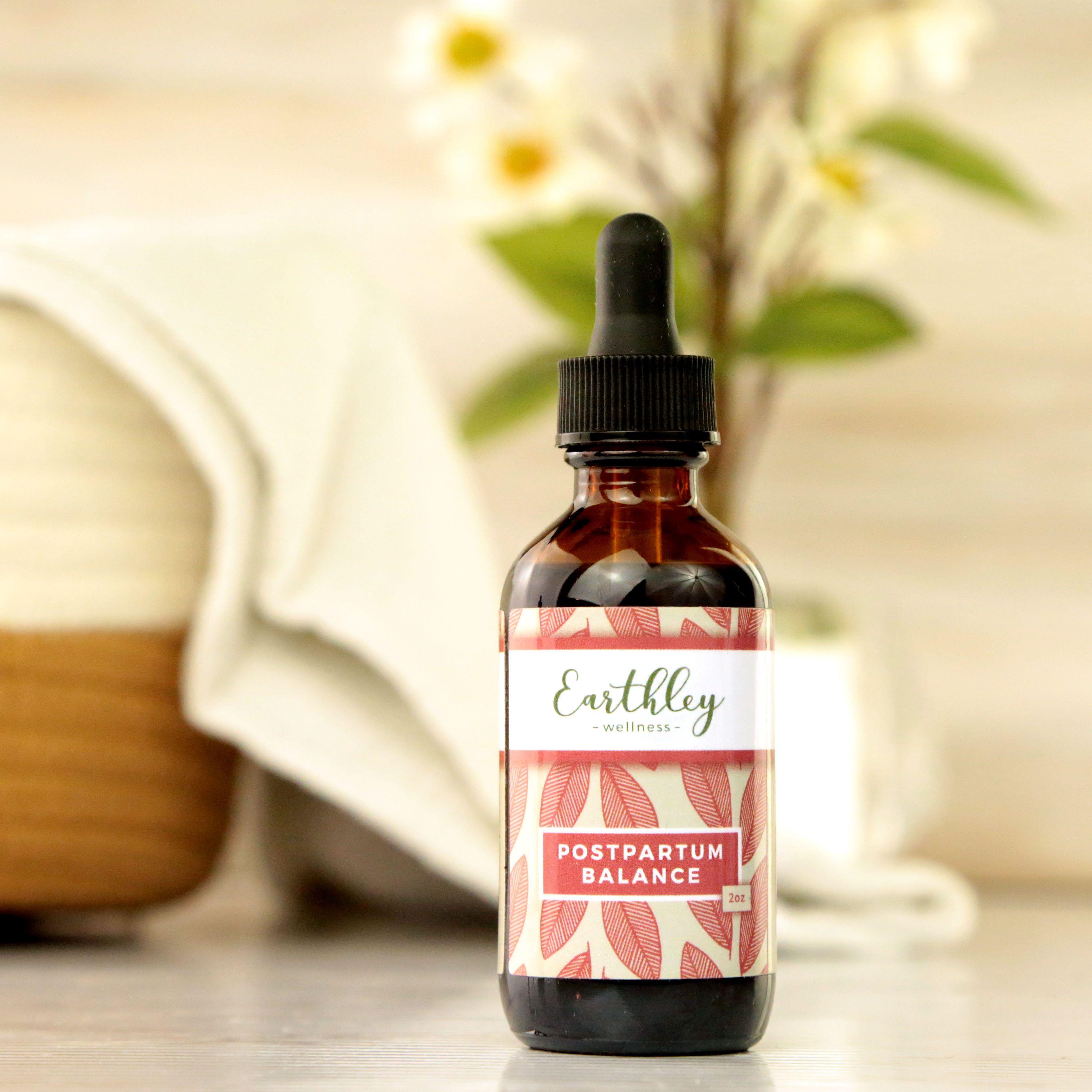 Earthley Postpartum Balance herbal extract amber dropper bottle with pink botanical label for hormone support after birth