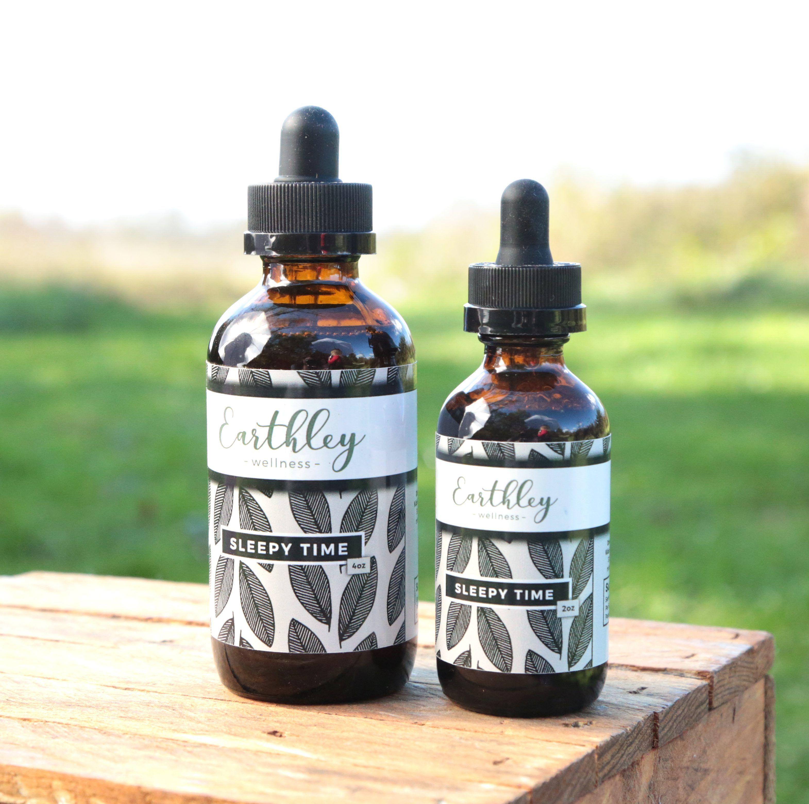 Earthley Sleepy Time herbal extract amber dropper bottle with purple lavender label for natural sleep support on lifestyle background
