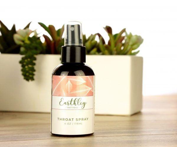 Throat Spray in dark glass bottle with pump sprayer and pink botanical label